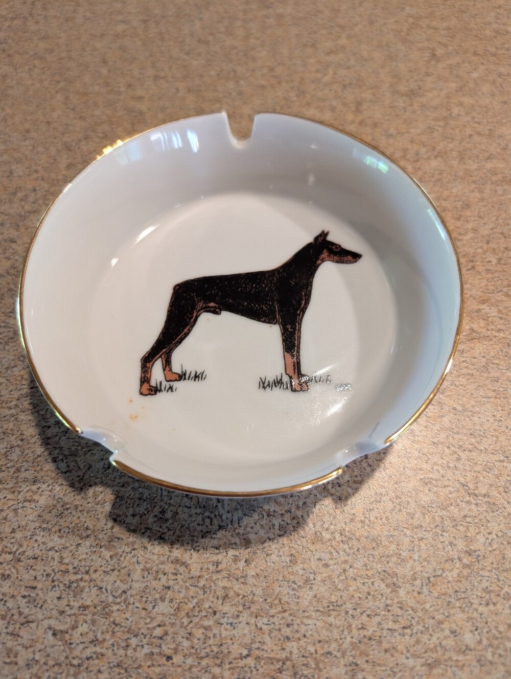 Vintage White Ceramic Ashtray W/ Gold Trim & Doberman Pincher In Center.